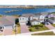Exterior view of home with solar panels on roof, nice landscaping and lake view at 3200 Canna Lily Pl, Clermont, FL 34711