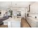 Open kitchen with white cabinets, stainless steel appliances, and view to staircase at 3200 Canna Lily Pl, Clermont, FL 34711