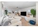 Spacious living room featuring a large sectional sofa, media center, and bright windows at 3200 Canna Lily Pl, Clermont, FL 34711