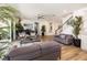 Beautiful living room with stairs to second level, a piano, plush seating, and light wood floors at 3200 Canna Lily Pl, Clermont, FL 34711