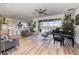 Bright living room features an open floor plan, piano, modern furniture and sliding doors with water view at 3200 Canna Lily Pl, Clermont, FL 34711