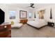 Serene main bedroom with calming decor and scenic water views from multiple windows at 3200 Canna Lily Pl, Clermont, FL 34711