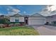 One-story home with red door, brick driveway, and landscaped lawn at 3537 Raleigh Dr, Winter Haven, FL 33884