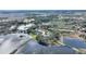 Aerial view of the home and surrounding community near a lake at 108 La Cresta Ct, Davenport, FL 33837