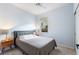 Bright bedroom with a gray bed, wooden nightstand and window coverings at 108 La Cresta Ct, Davenport, FL 33837