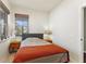 Bedroom with gray bed, orange blanket, and a view of the backyard at 108 La Cresta Ct, Davenport, FL 33837