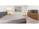 King-size bed, dresser, and TV in this well-lit bedroom at 108 La Cresta Ct, Davenport, FL 33837
