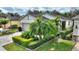 House exterior showing a gray garage door, palm trees, and well-maintained landscaping at 108 La Cresta Ct, Davenport, FL 33837