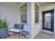 Front entrance with black door, small sitting area, and potted plant at 108 La Cresta Ct, Davenport, FL 33837