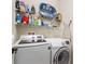 Bright laundry room with washer, dryer, and shelving for storage at 108 La Cresta Ct, Davenport, FL 33837