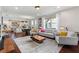 Open living room with hardwood floors, modern furniture, and kitchen views at 108 La Cresta Ct, Davenport, FL 33837