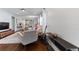Living room with hardwood floors, comfortable seating, and a view into the kitchen at 108 La Cresta Ct, Davenport, FL 33837
