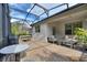 Relaxing covered patio with seating area, grill, and outdoor dining at 108 La Cresta Ct, Davenport, FL 33837
