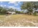 Spacious backyard with various outbuildings at 2028 Marker Rd, Polk City, FL 33868
