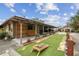 Landscaped backyard with cornhole and covered patio area at 2028 Marker Rd, Polk City, FL 33868