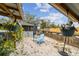 Sandy backyard with a blue chair and plants at 2028 Marker Rd, Polk City, FL 33868