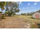 Large backyard with mature trees and a shed at 2028 Marker Rd, Polk City, FL 33868