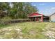 Red barn with attached run and fenced area at 2028 Marker Rd, Polk City, FL 33868