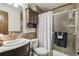 Clean bathroom with shower/tub combo, vanity, and updated tile at 2028 Marker Rd, Polk City, FL 33868