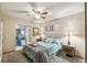 Bedroom with carpeted floor, ceiling fan, and built-in shelving at 2028 Marker Rd, Polk City, FL 33868