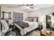 Spacious bedroom with a queen bed, ceiling fan, and comfy chair at 2028 Marker Rd, Polk City, FL 33868