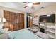 Bright bedroom with wood closet doors, TV stand, and ceiling fan at 2028 Marker Rd, Polk City, FL 33868