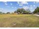 Spacious front yard with large tree and detached workshop at 2028 Marker Rd, Polk City, FL 33868
