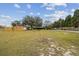 Spacious front yard with large tree and detached workshop at 2028 Marker Rd, Polk City, FL 33868