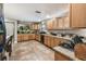 Spacious kitchen featuring ample cabinetry, granite countertops, and tile flooring at 2028 Marker Rd, Polk City, FL 33868