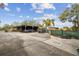 Large parking area with covered carport and space for multiple vehicles at 2028 Marker Rd, Polk City, FL 33868