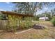 Small shed nestled in a lush garden setting at 2028 Marker Rd, Polk City, FL 33868