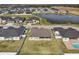 Aerial view of a house and neighborhood with a pond at 7021 Bentridge Dr, Lakeland, FL 33813