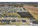 Aerial view of a new residential community with numerous homes and a lake at 7021 Bentridge Dr, Lakeland, FL 33813