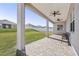 Covered patio with pavers, ceiling fan, and seating area, overlooking a grassy backyard at 7021 Bentridge Dr, Lakeland, FL 33813