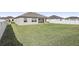 Large grassy backyard with a home and white fence at 7021 Bentridge Dr, Lakeland, FL 33813
