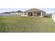 Large grassy backyard with a home and white fence at 7021 Bentridge Dr, Lakeland, FL 33813