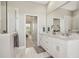 Spa-like bathroom with double vanity and marble flooring at 7021 Bentridge Dr, Lakeland, FL 33813