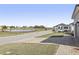 View of a quiet street with a pond in the background at 7021 Bentridge Dr, Lakeland, FL 33813