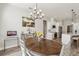 Bright dining room features chandelier and view into kitchen at 7021 Bentridge Dr, Lakeland, FL 33813