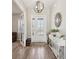 Bright and airy entryway with wood floors and console table at 7021 Bentridge Dr, Lakeland, FL 33813