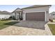 Exterior view of house with a brick driveway and garage at 7021 Bentridge Dr, Lakeland, FL 33813