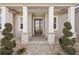 Front entrance with stone columns and a dark door at 7021 Bentridge Dr, Lakeland, FL 33813