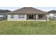 Single-story home with a covered patio and grassy backyard at 7021 Bentridge Dr, Lakeland, FL 33813