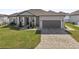 Single-story home with a two-car garage and landscaping at 7021 Bentridge Dr, Lakeland, FL 33813