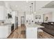 Modern kitchen with white cabinets, marble island, and stainless steel appliances at 7021 Bentridge Dr, Lakeland, FL 33813