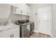 Bright laundry room with washer, dryer, and white cabinets at 7021 Bentridge Dr, Lakeland, FL 33813