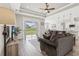 Spacious living room with hardwood floors and sliding glass doors to backyard at 7021 Bentridge Dr, Lakeland, FL 33813