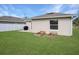 Spacious backyard with grassy lawn, raised garden beds, and patio at 1314 W Highland St, Lakeland, FL 33815