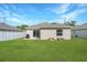 Backyard view of home with patio and lawn at 1314 W Highland St, Lakeland, FL 33815