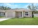 Newly constructed one-story home with a neutral color palette and a neatly landscaped lawn at 1314 W Highland St, Lakeland, FL 33815
